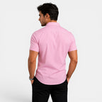Man wearing a pink short-sleeve shirt on a white background