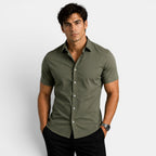Man wearing a green shirt against a white background