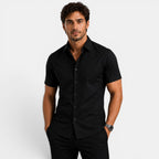 Man wearing a black short-sleeve shirt against a white background