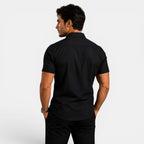 Man wearing a black short-sleeve shirt on a white background