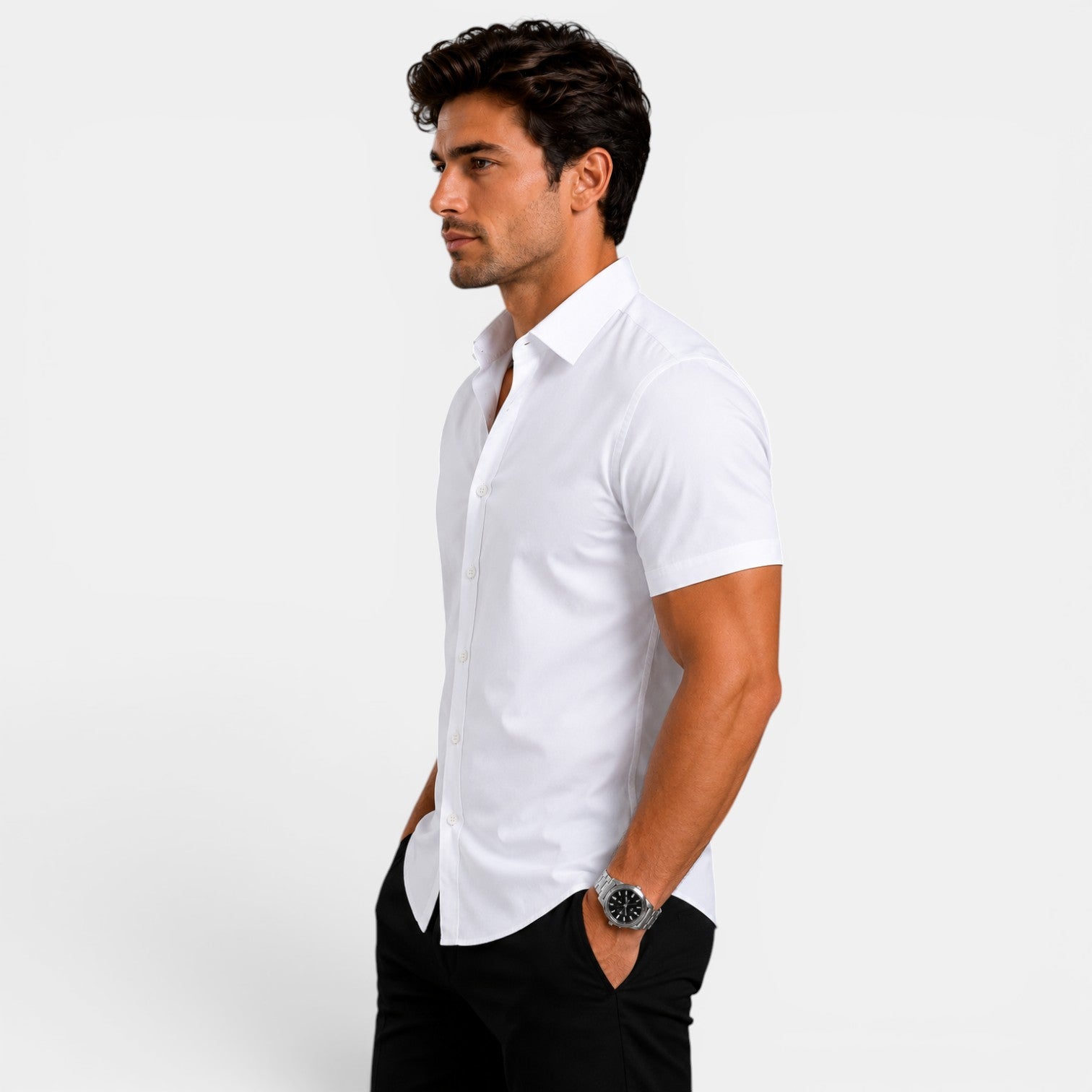Man wearing a white short-sleeve shirt and black pants on a light gray background