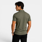 Man wearing a green polo shirt on a white background