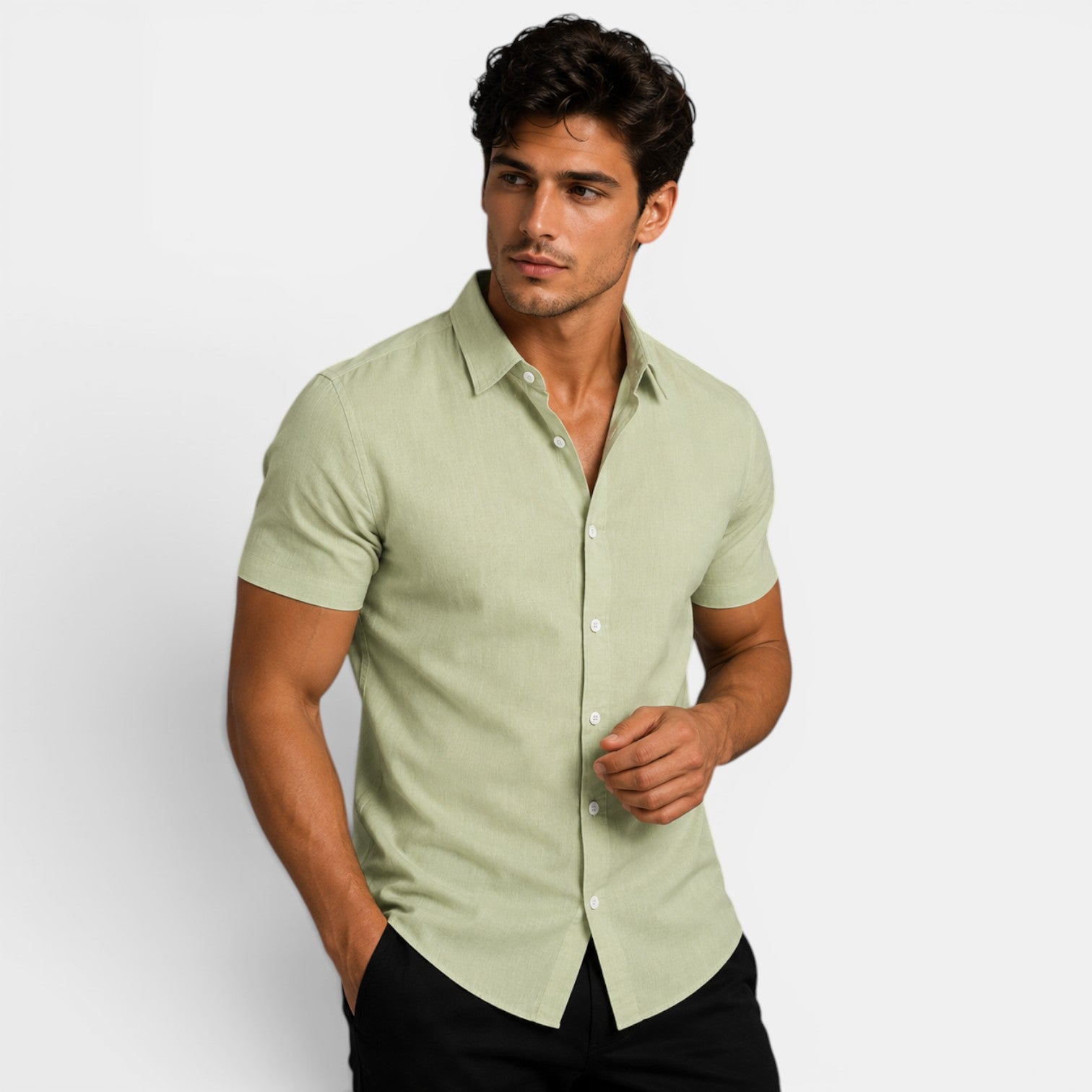 Man wearing a light green short-sleeve shirt against a white background