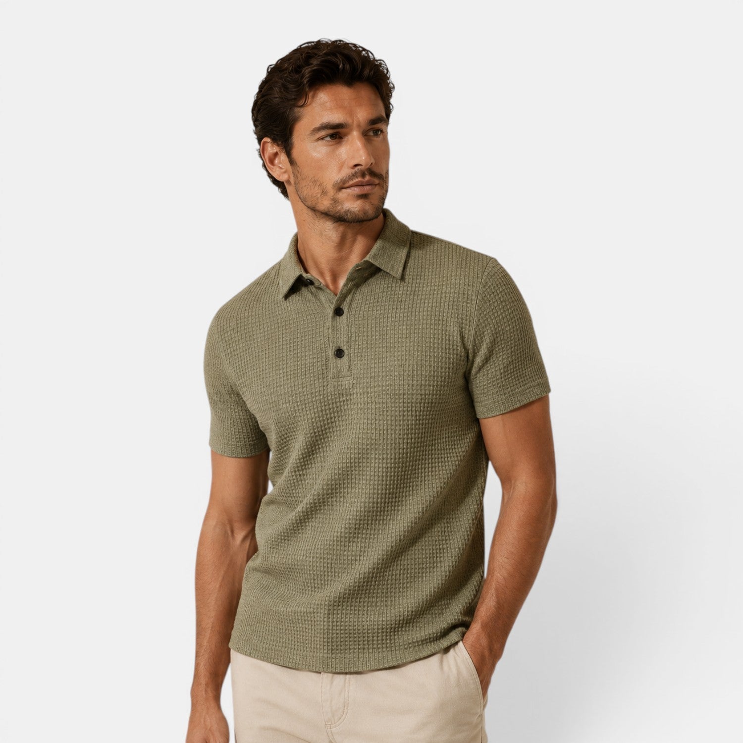 Man wearing a green patterned polo shirt on a white background
