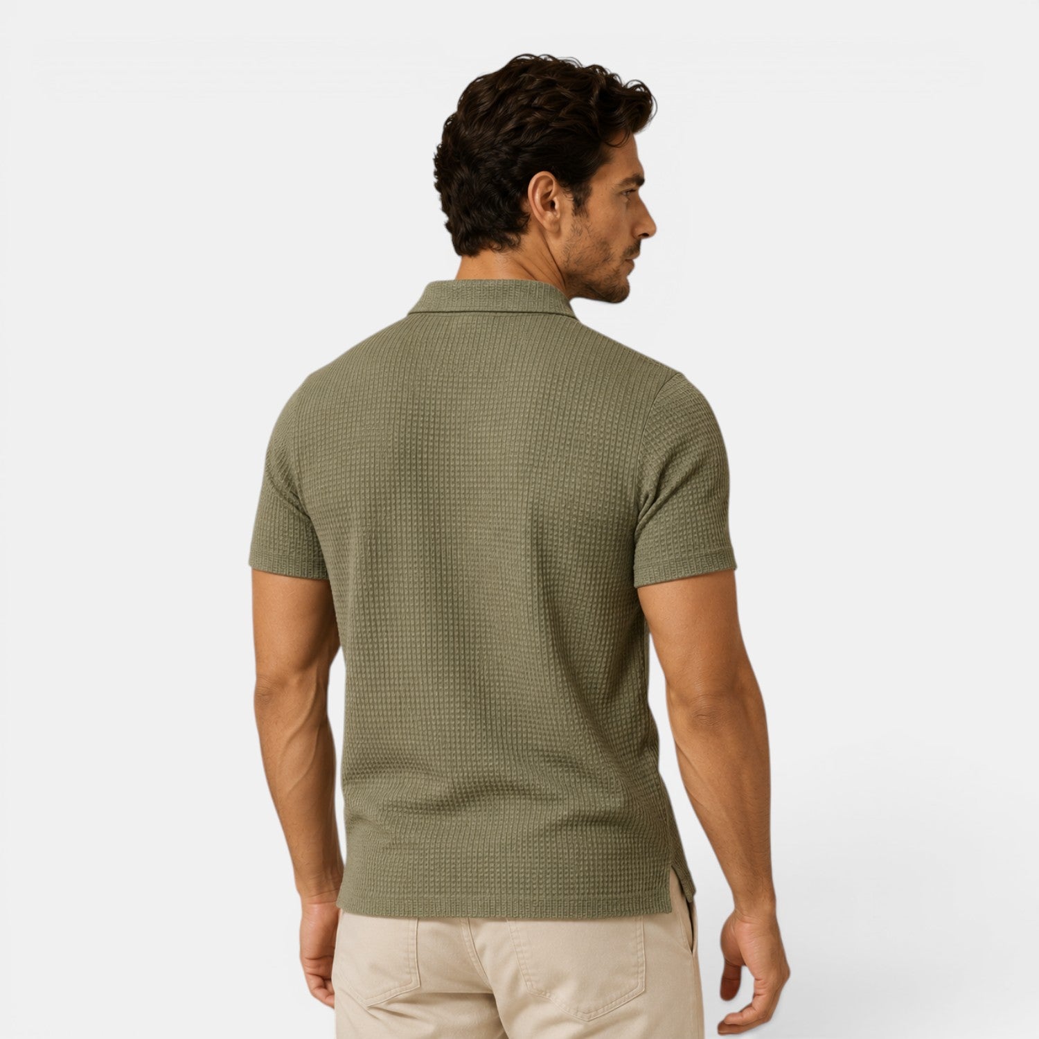 Man wearing a green patterned polo shirt on a white background