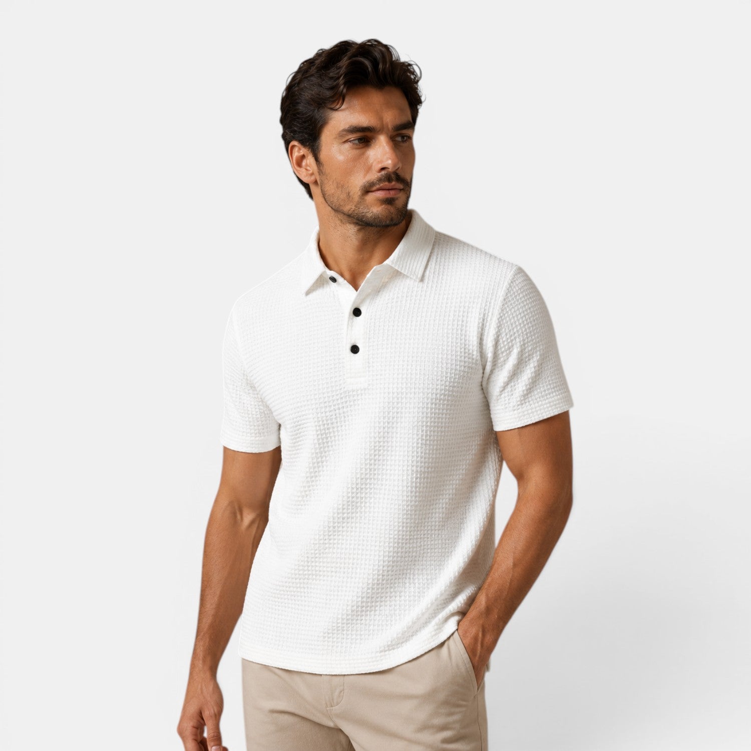 Man wearing a white textured polo shirt against a light gray background