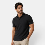 Man wearing a black textured polo shirt against a light gray background