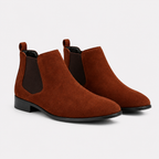 A pair of brown suede Chelsea boots with dark brown elastic side panels and black soles, shown on a light gray background.