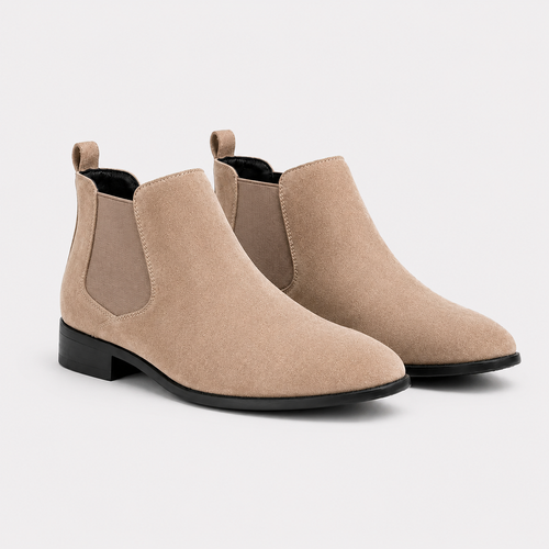 A pair of beige suede Chelsea boots with black soles, displayed on a clean light gray background.