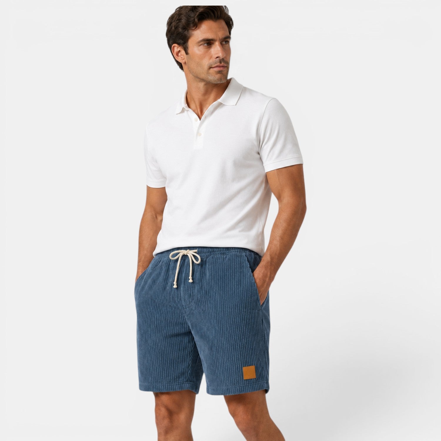 Man wearing a white polo shirt and blue shorts on a white background