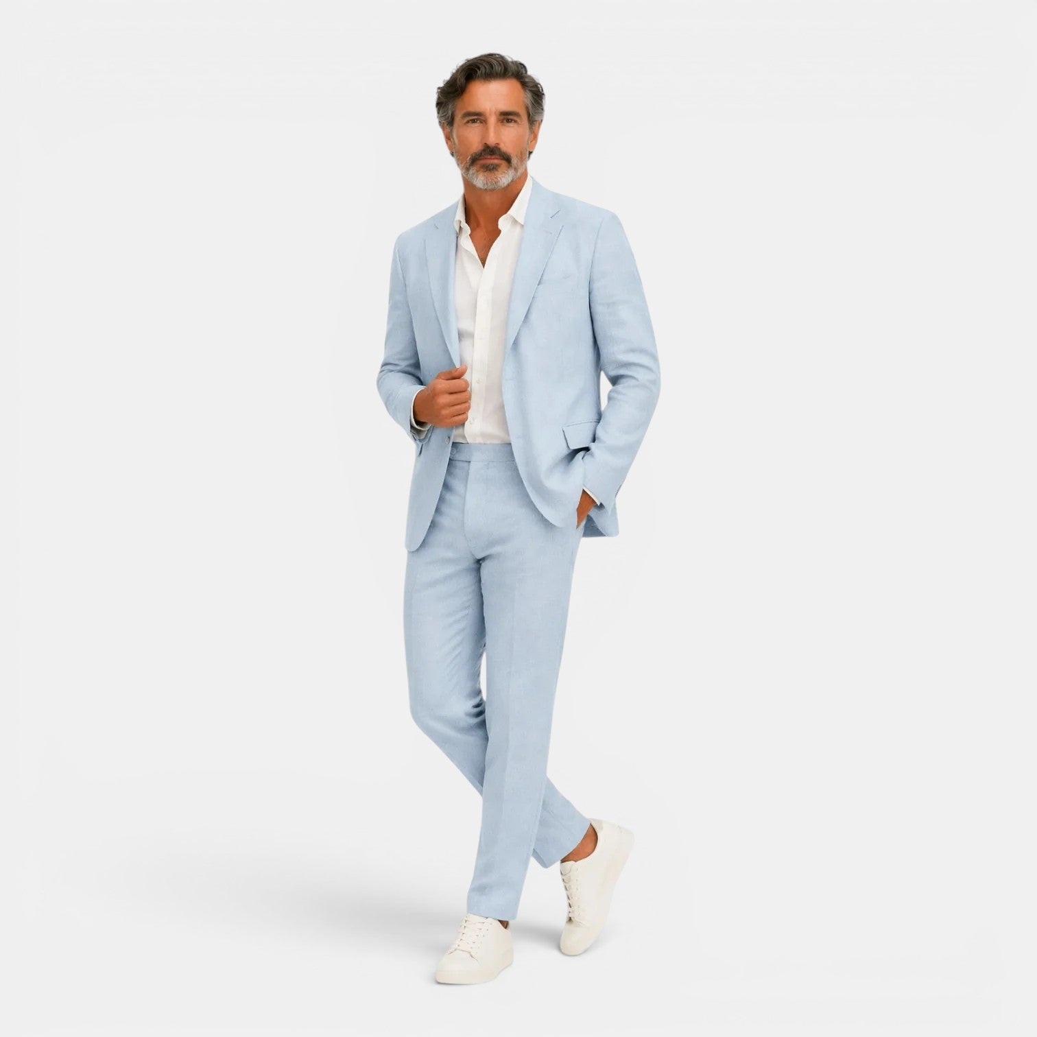 Man wearing a light blue suit with a white shirt on a white background