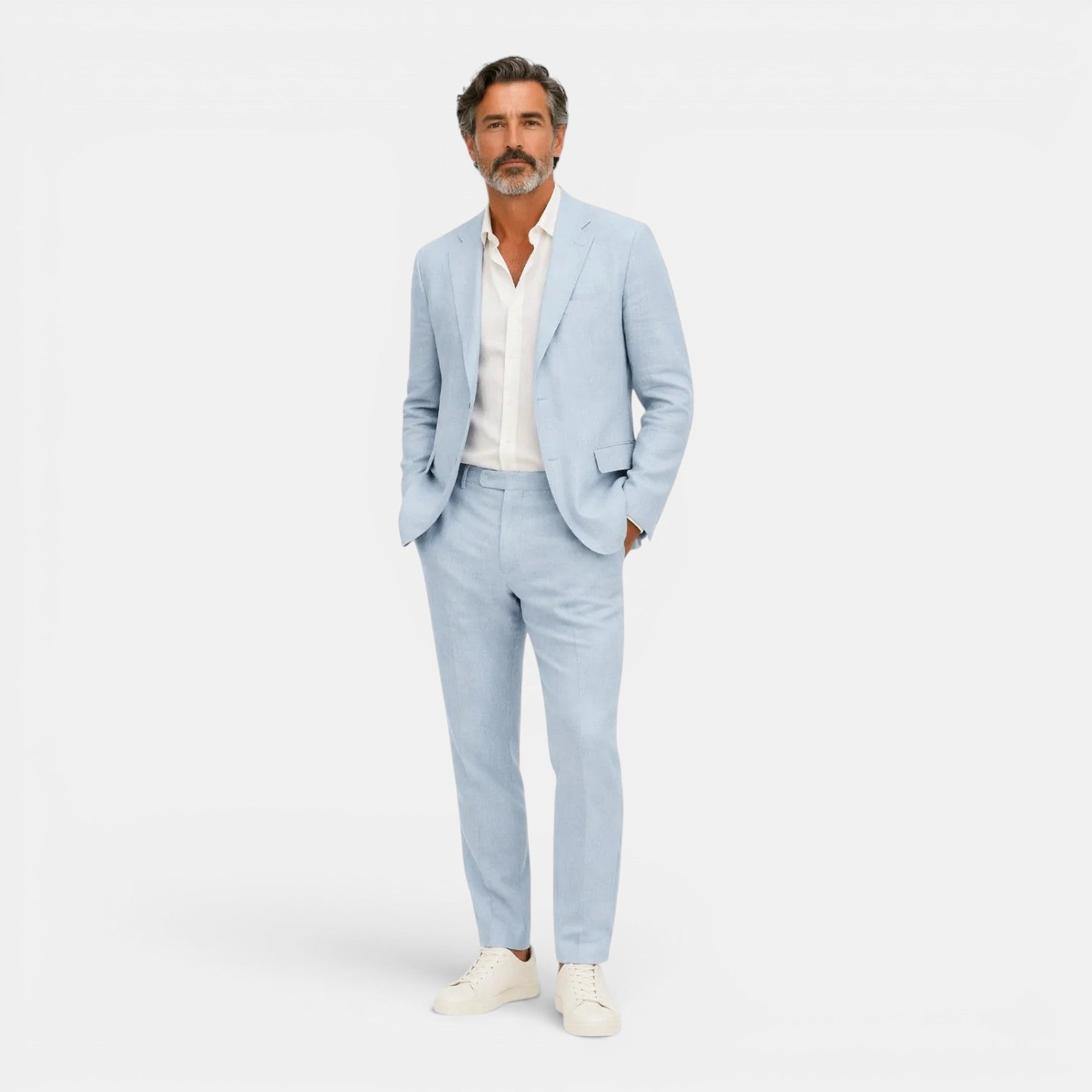 Man wearing a light blue suit with a white shirt on a white background