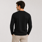 A man wearing a black long-sleeve crewneck sweater, shown from the back against a light gray studio background.