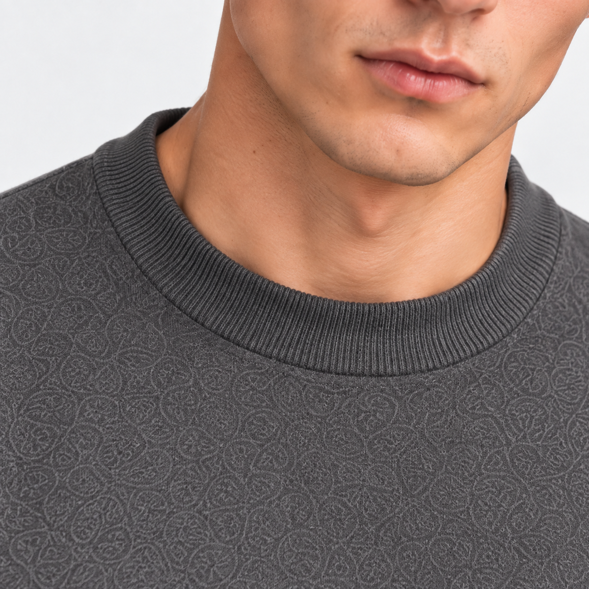 Close-up of men's gray T-shirt with classic crew neckline and textured knit fabric