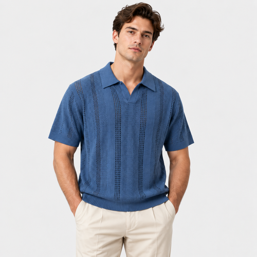 A man wearing a blue short-sleeve knit polo shirt with vertical textured stripes and beige trousers, standing against a light gray studio background.