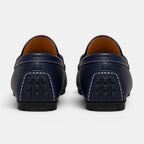 Pair of navy blue leather loafers on a white background