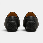Black leather loafers on a white background