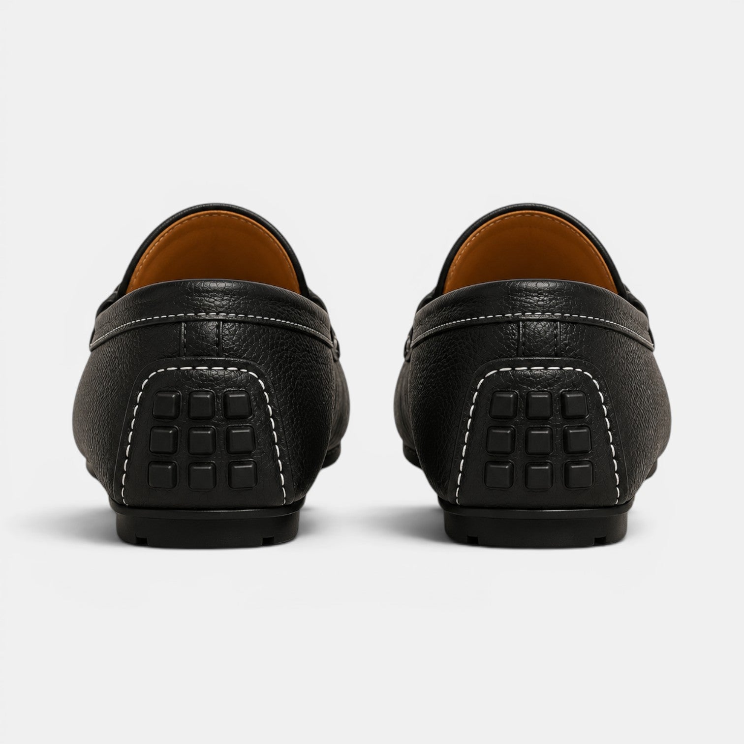Black leather loafers on a white background