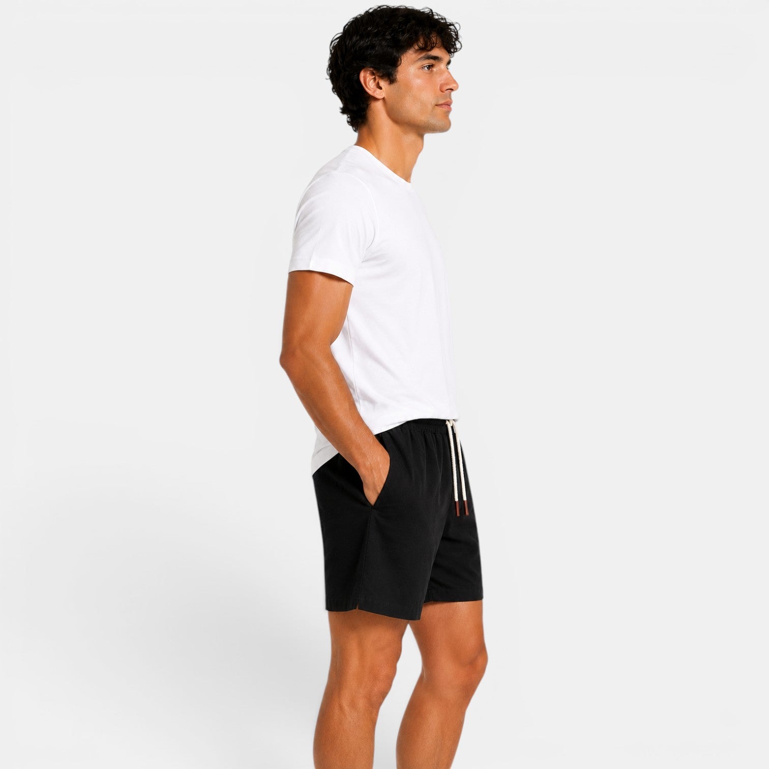 Man wearing a white t-shirt and black shorts on a white background