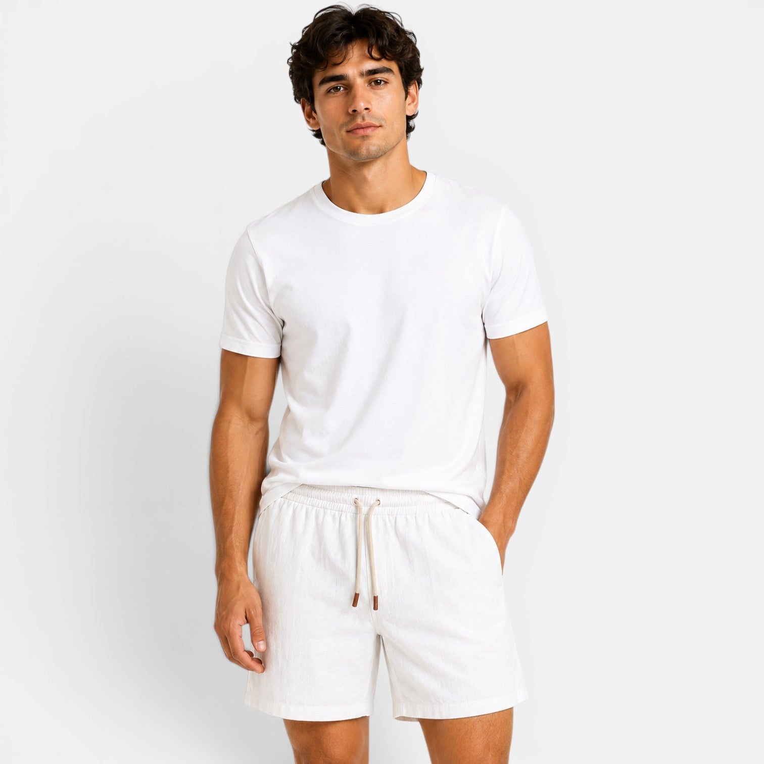 Man wearing a white t-shirt and shorts on a plain background