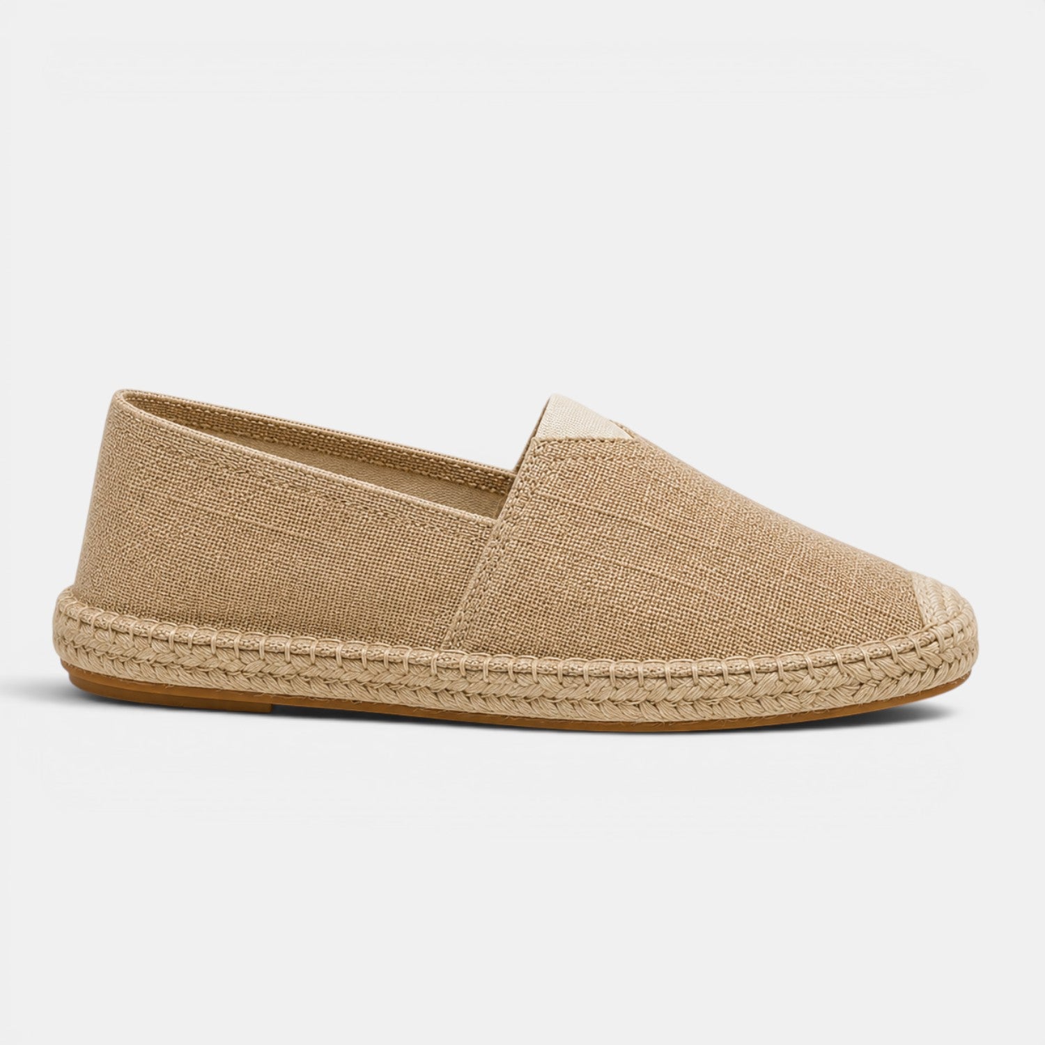 Beige espadrille shoe on a light gray background