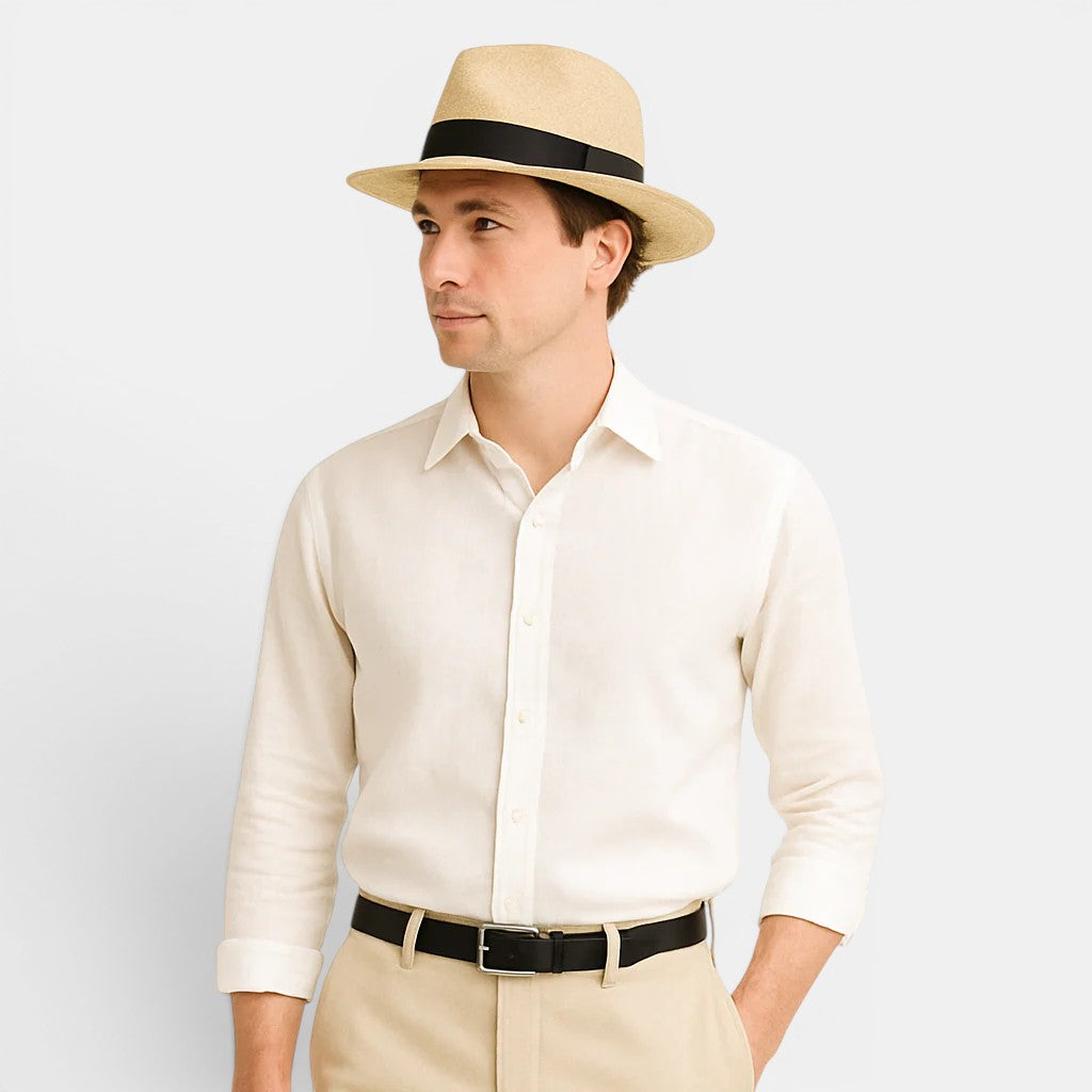 Man wearing a beige hat, white shirt, and beige pants on a light gray background