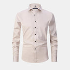 Beige dress shirt with black buttons on a white background