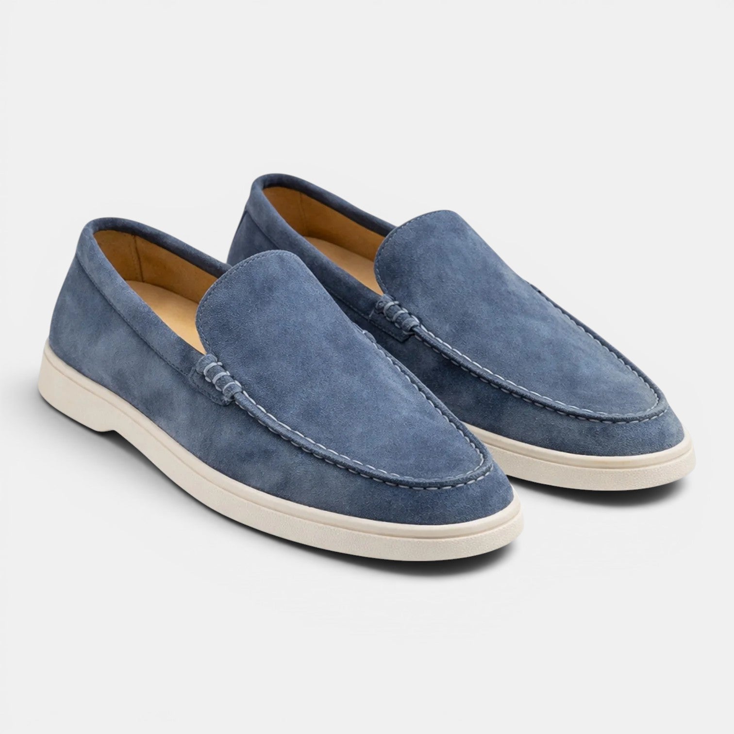 Pair of blue loafers on a light gray background