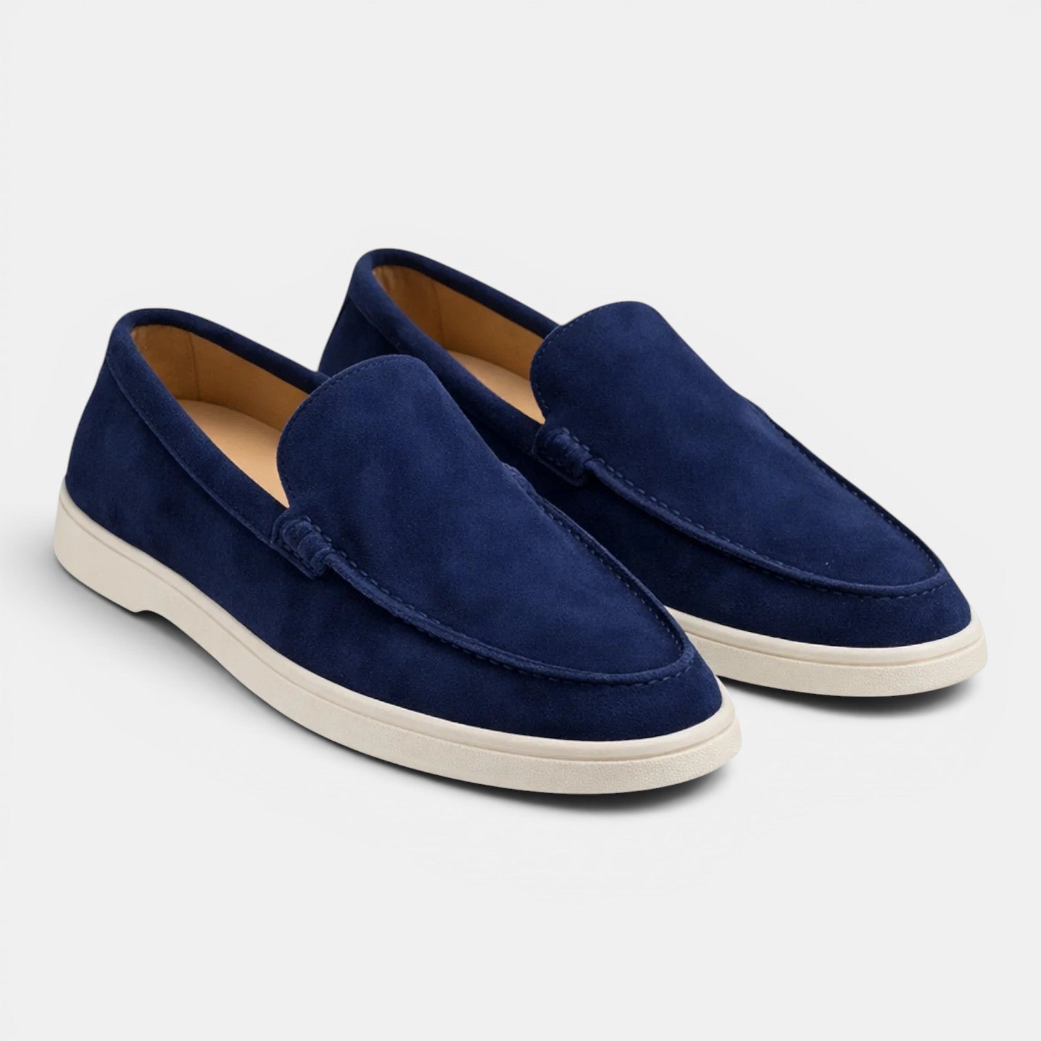 Pair of navy blue loafers on a light gray background