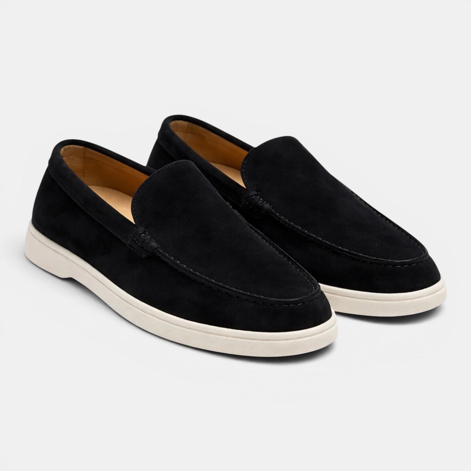 Pair of black loafers on a light gray background