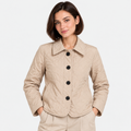 Women's beige quilted jacket with pointed collar, black buttons, and front pockets