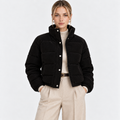 Women's black quilted puffer jacket with high collar, snap buttons, and front pockets