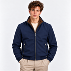 Men's navy blue zip-up bomber jacket styled with a cream sweater and beige trousers