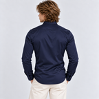 Back view of a men's navy blue long sleeve button-down shirt