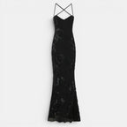 Black lace evening gown with thin straps on a light gray background