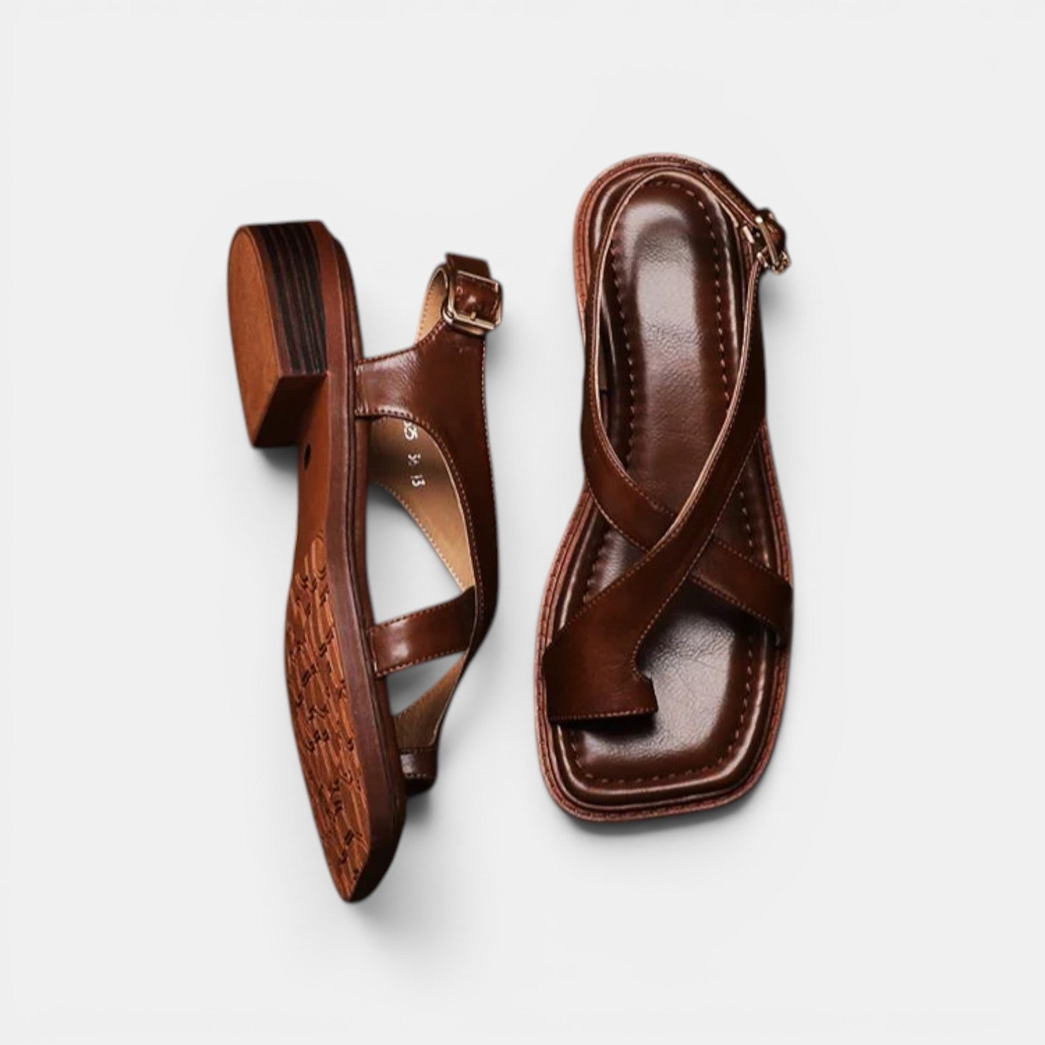 Pair of brown sandals on a light gray background