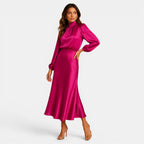 Woman wearing a pink satin outfit on a white background