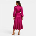 Woman wearing a pink satin dress on a white background