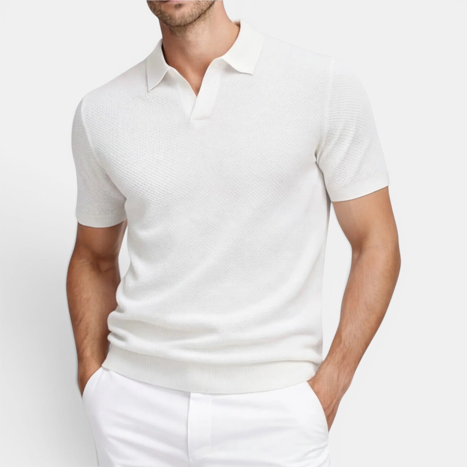 Man wearing a white short-sleeve shirt and pants on a light gray background