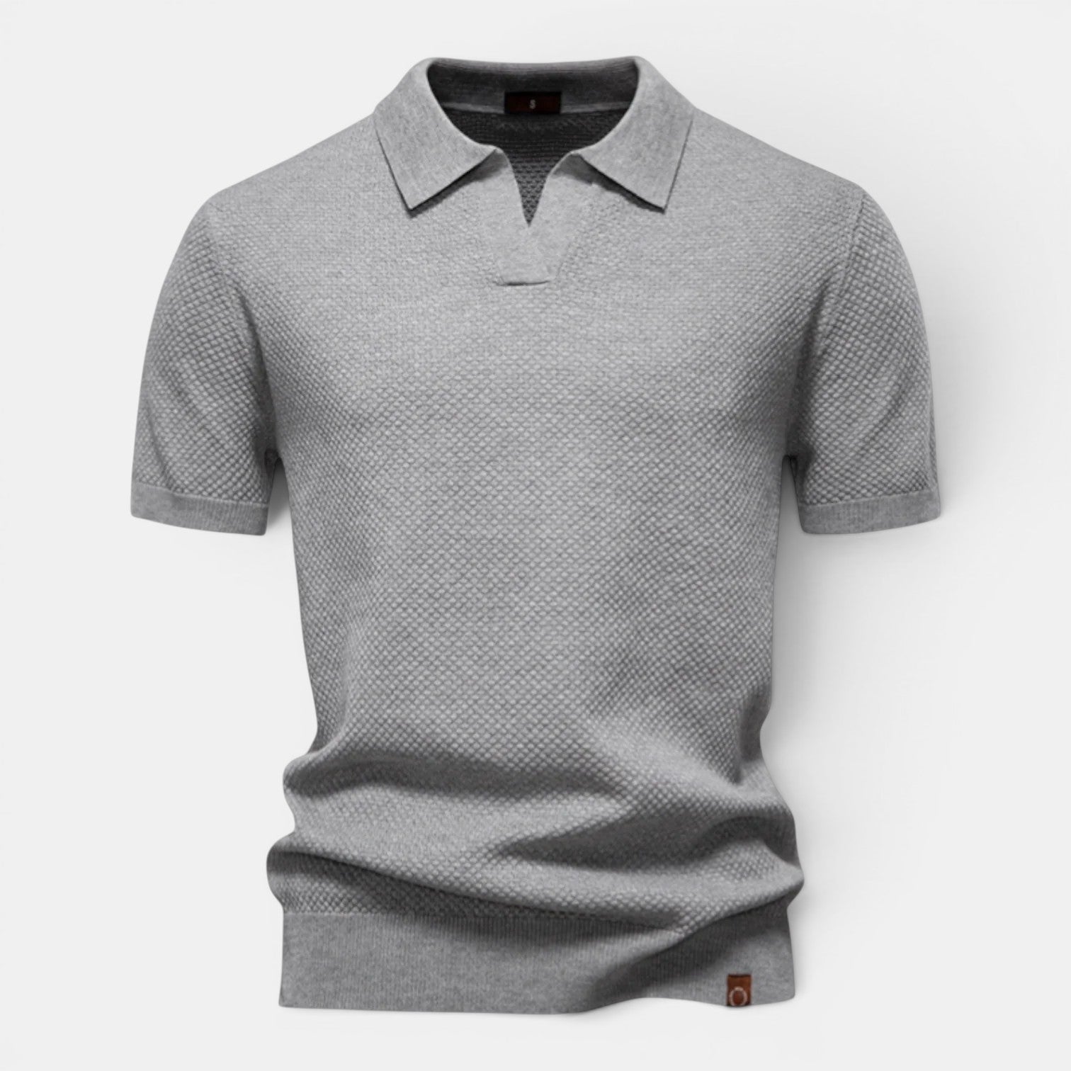 Gray patterned polo shirt on a light gray background