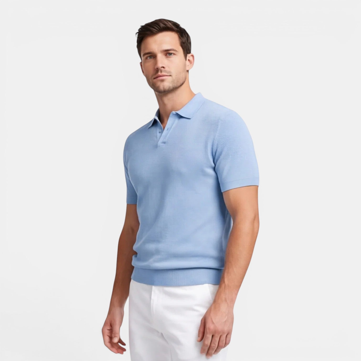 Man wearing a light blue polo shirt and white pants on a plain background