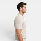 Man wearing a beige short-sleeve shirt on a white background