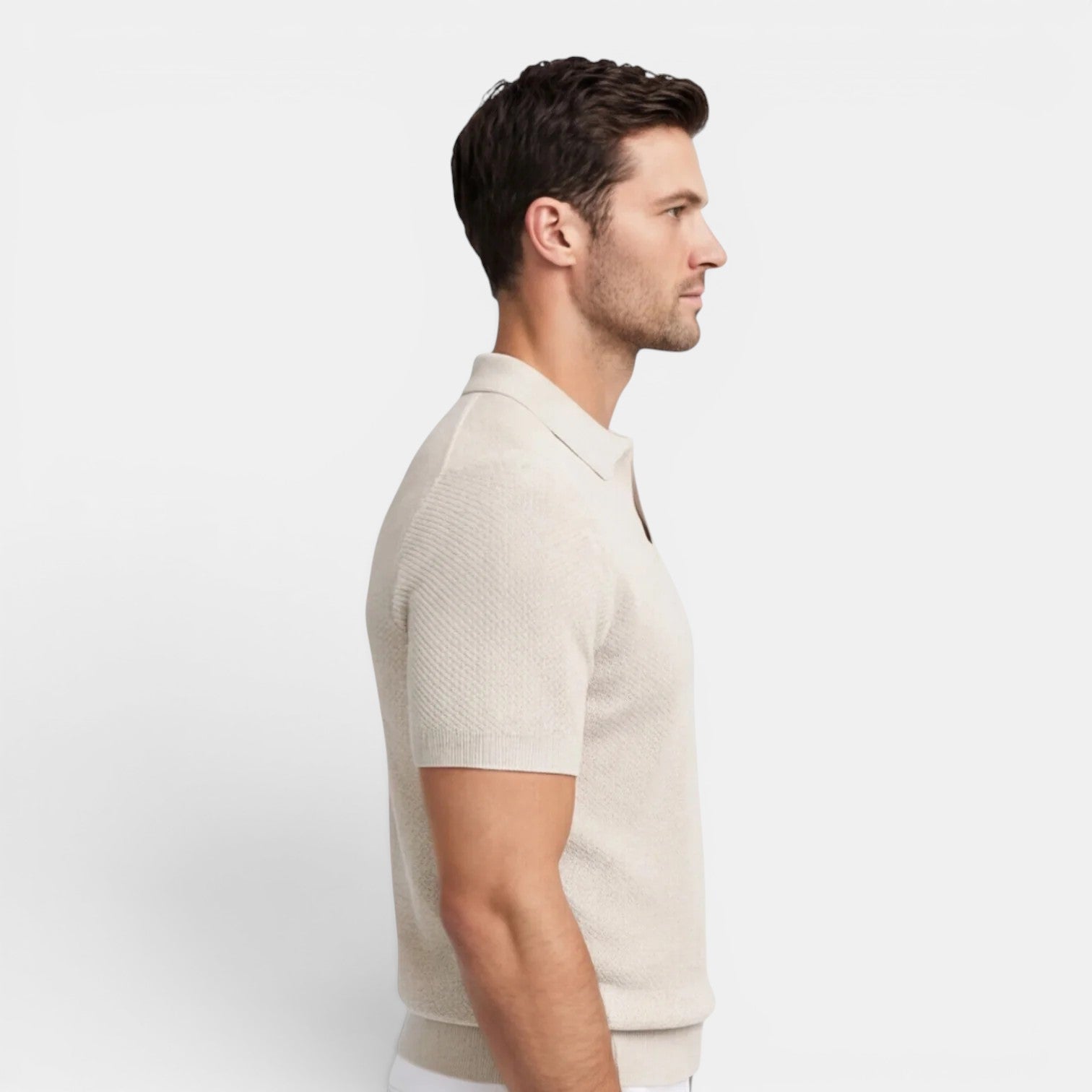 Man wearing a beige short-sleeve shirt on a white background