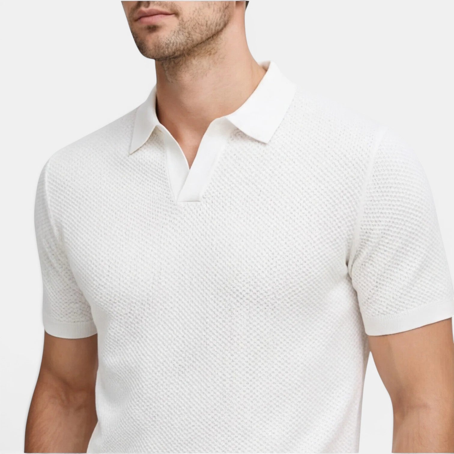 White textured polo shirt worn by a person on a white background