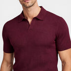 Maroon polo shirt worn by a person on a light gray background