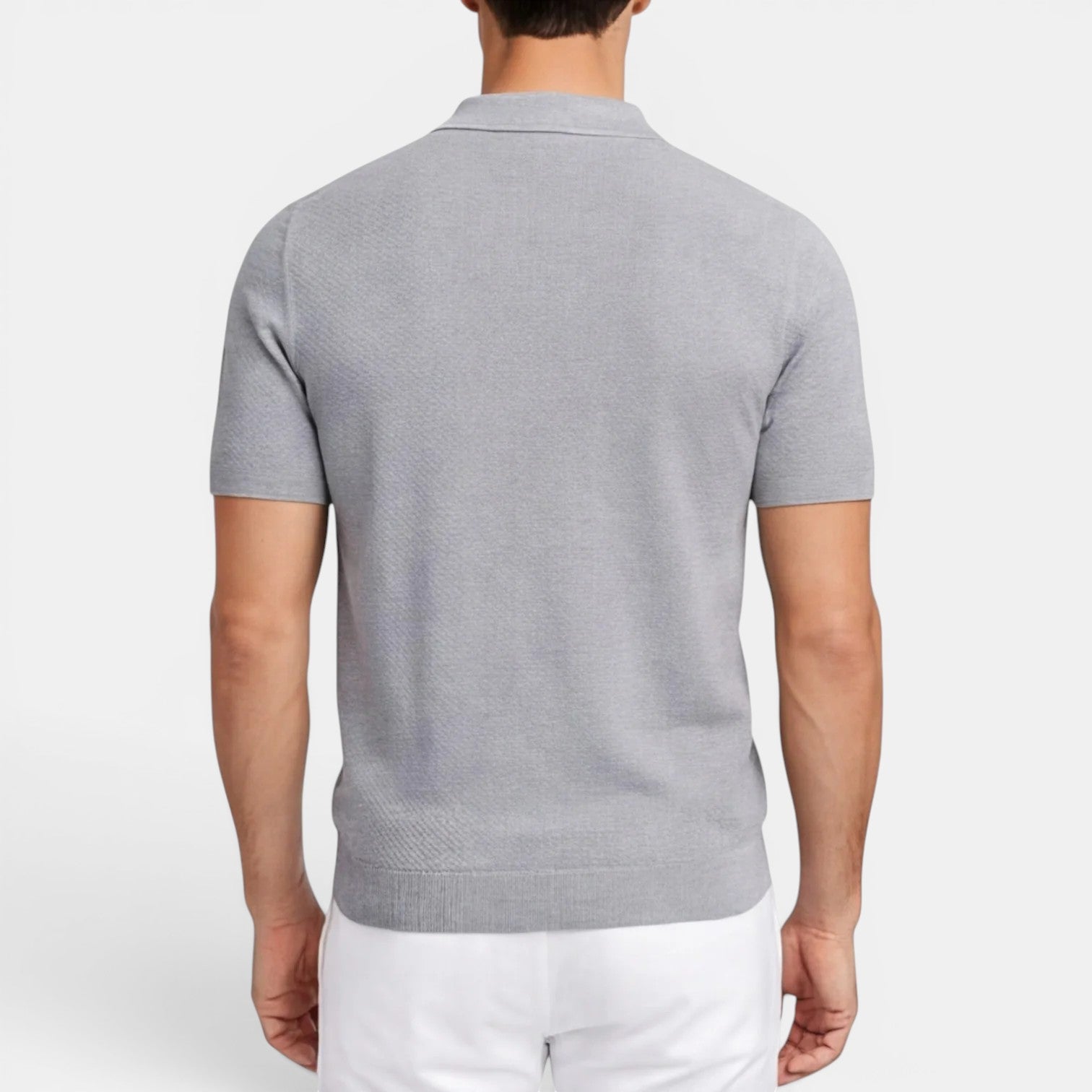 Man wearing a gray short-sleeve polo shirt on a white background