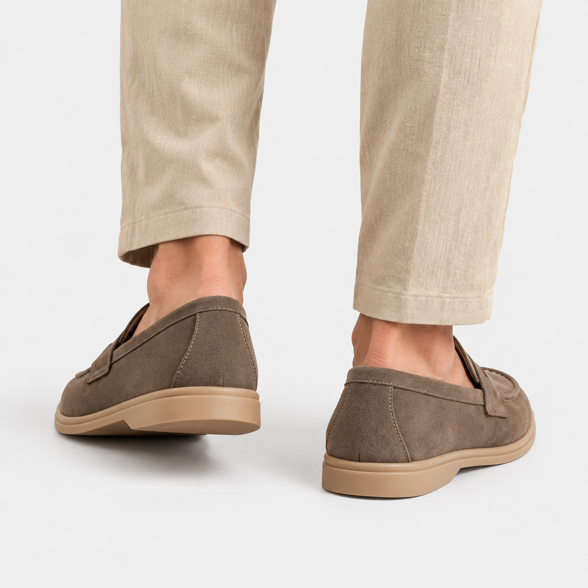 Back view of men's brown suede loafers with flat soles
