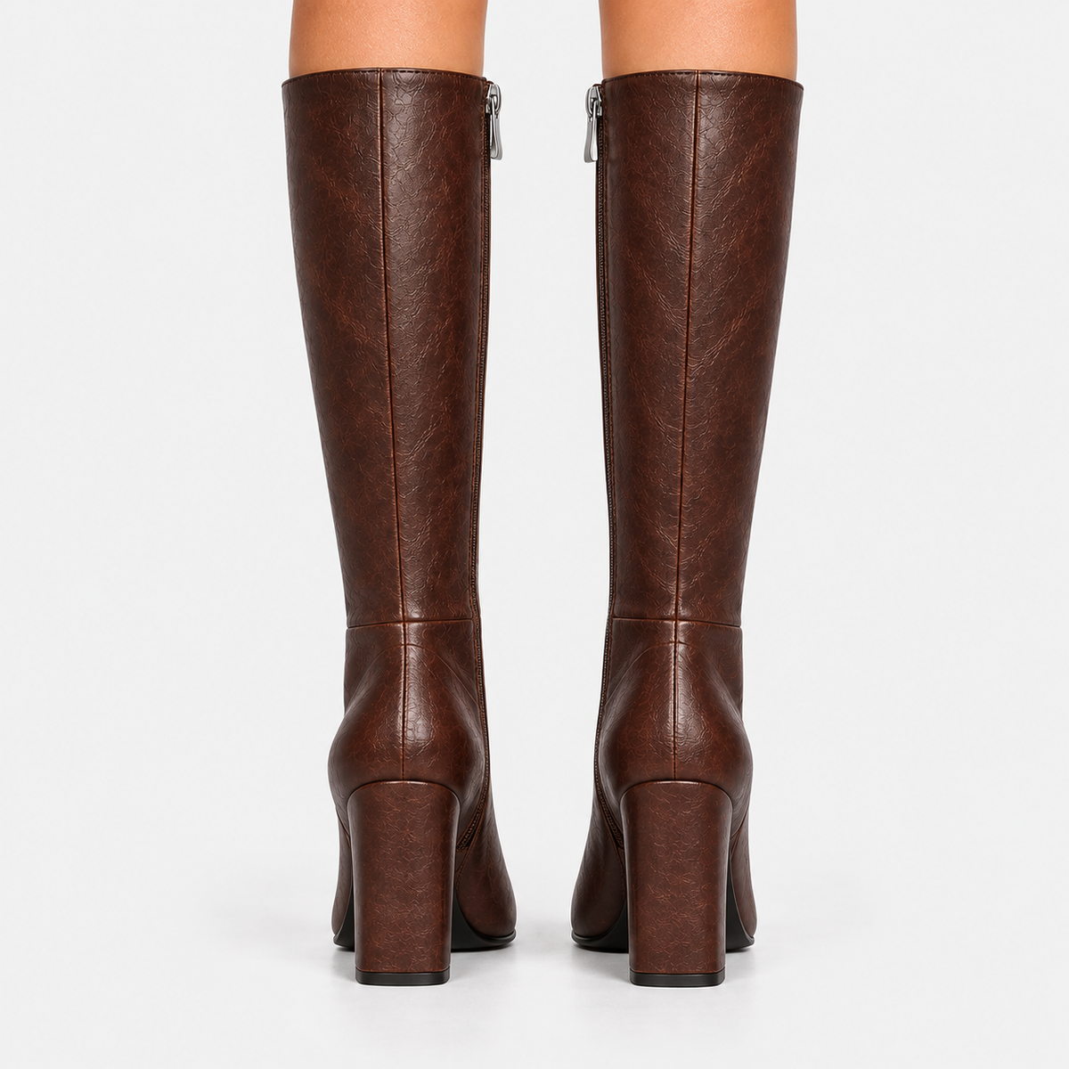 Back view of women's dark brown knee-high boots with block heels and back seams
