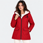A woman wearing a red hooded parka jacket with a white sherpa-lined hood, black zipper, and front flap pockets, photographed against a light gray studio background.