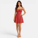 Woman wearing a red floral dress on a white background